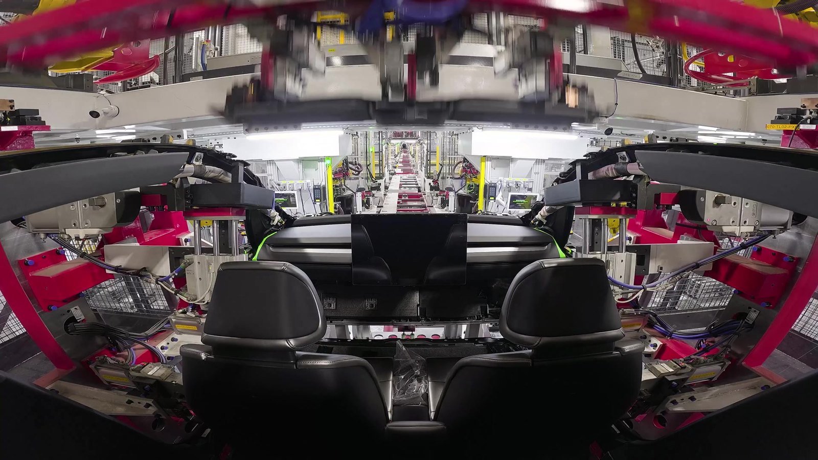 Kadr z filmu Tesli: Cybercab między robotami na linii Unboxed